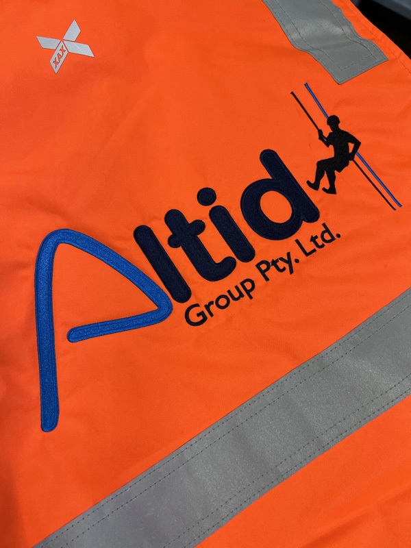 ALTID Group branding on hi vis vest